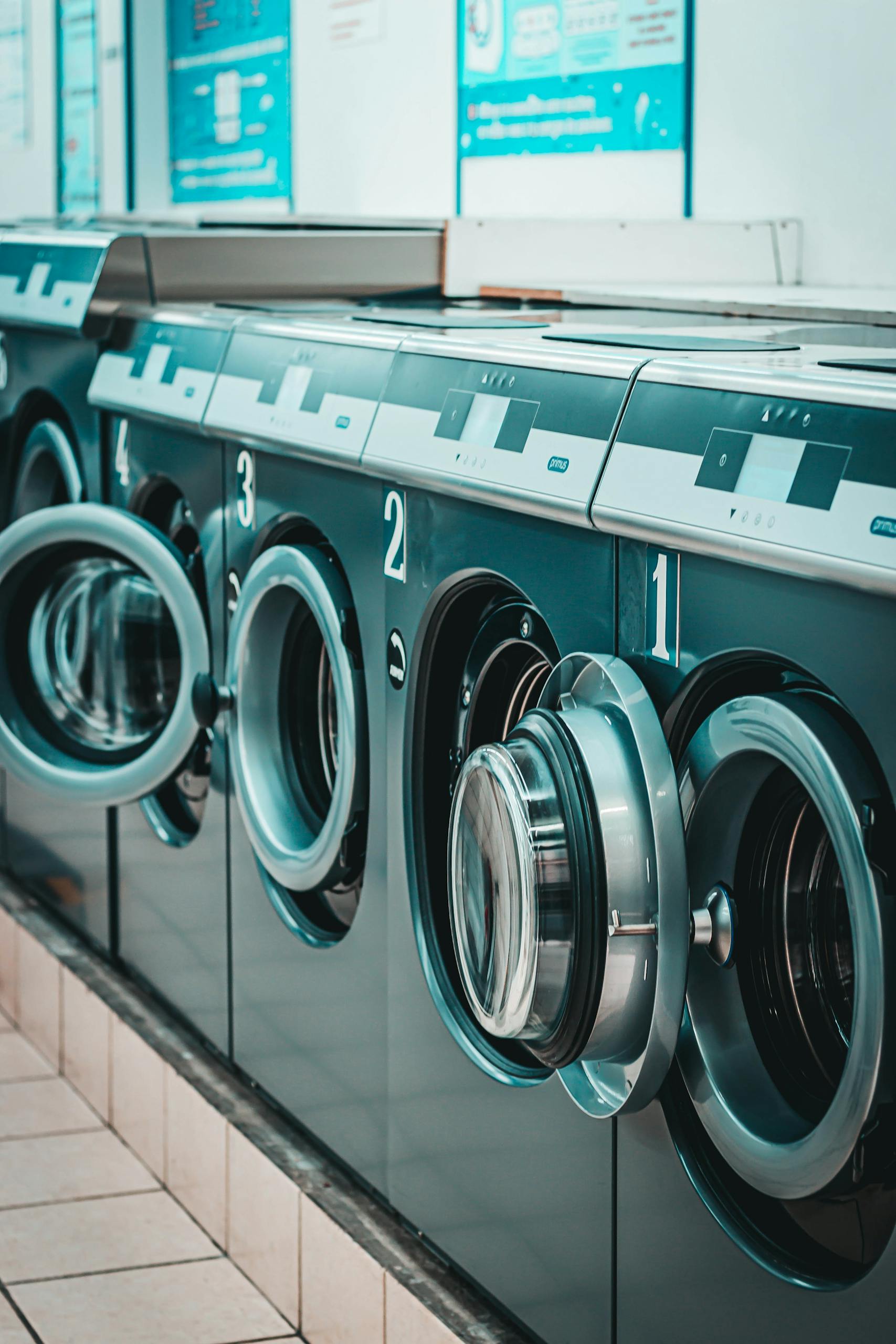 Row of modern washing machines in laundry
