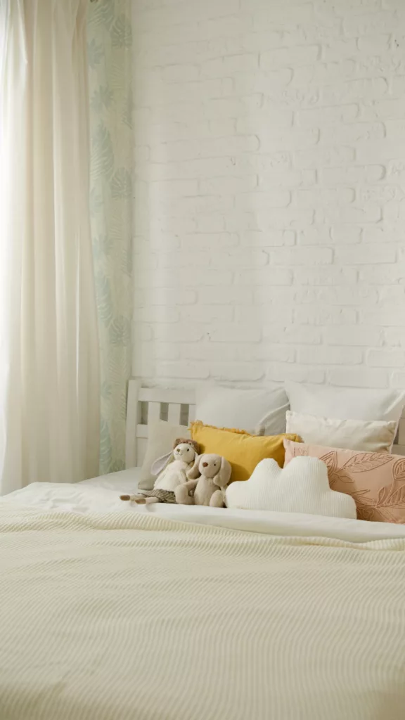 a bed with stuffed animals and pillows nursery ideas